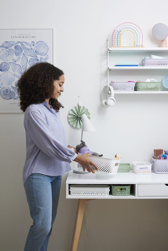 A woman inserting kids toy to SmartStore Essence storage basket